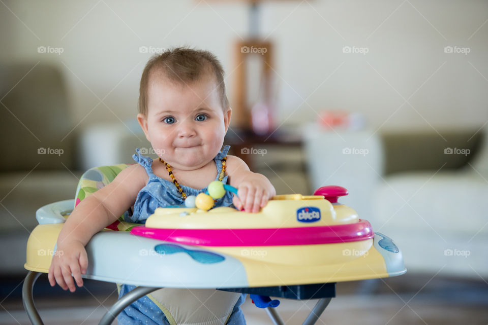 cute baby girl in a walker