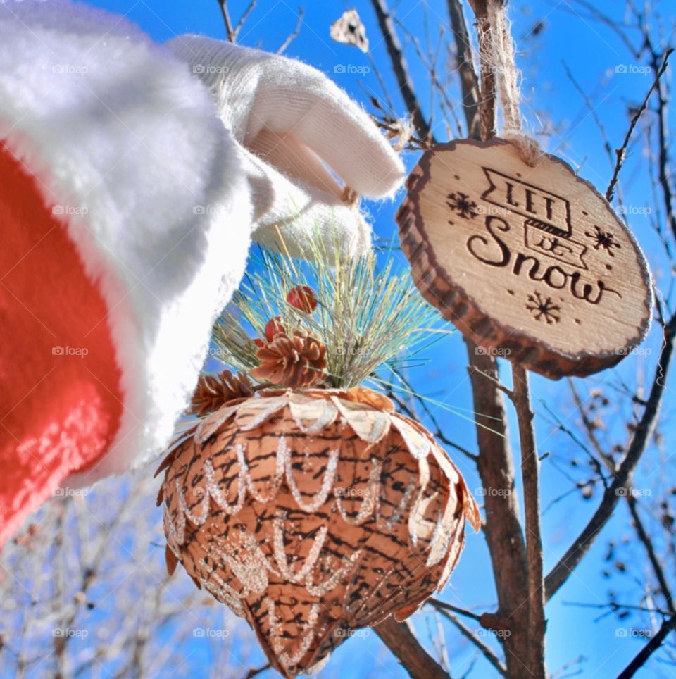 Santa hanging ornaments outside 🎄