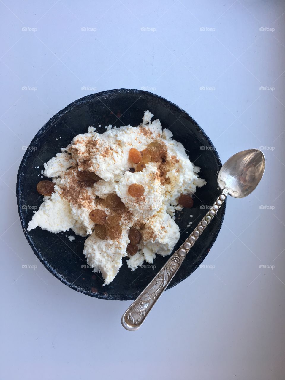 Cheese with dried grape with silver spoon for breakfast 