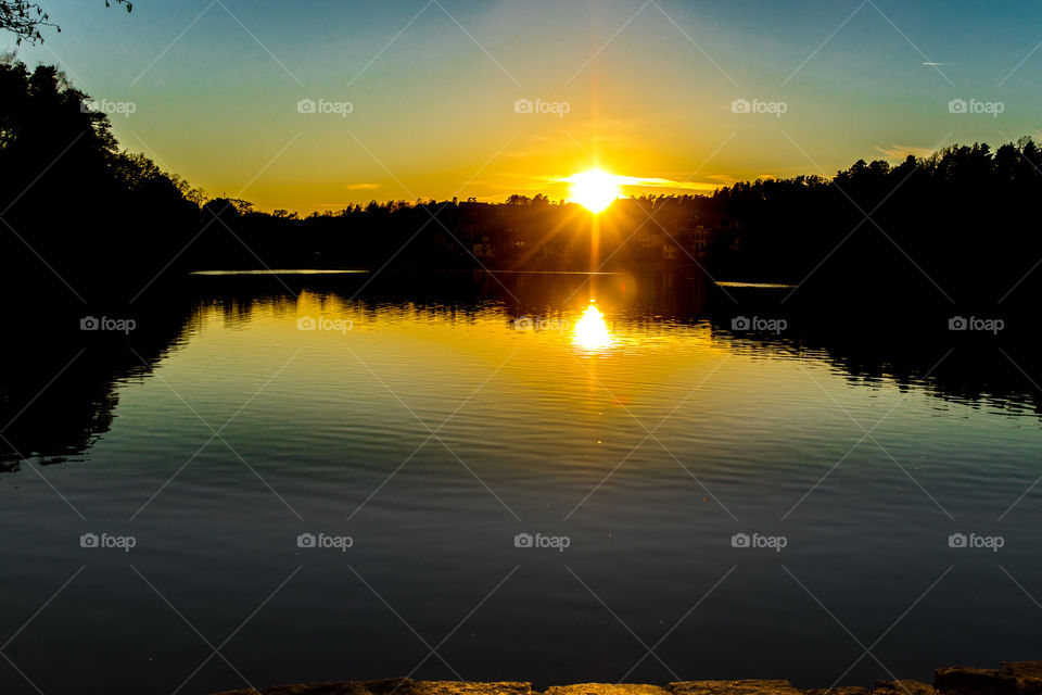 an amazing sunset over a calm lake in Swedish city Park