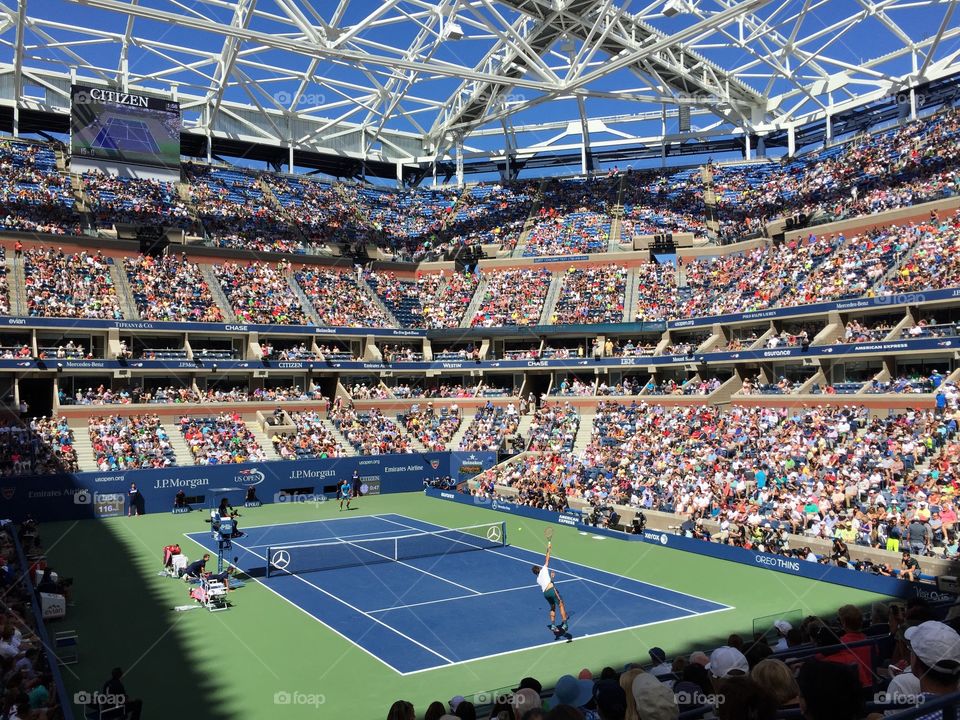 The big tennis match. Tennis lovers watching professionals compete in a high profile match at the US Open
