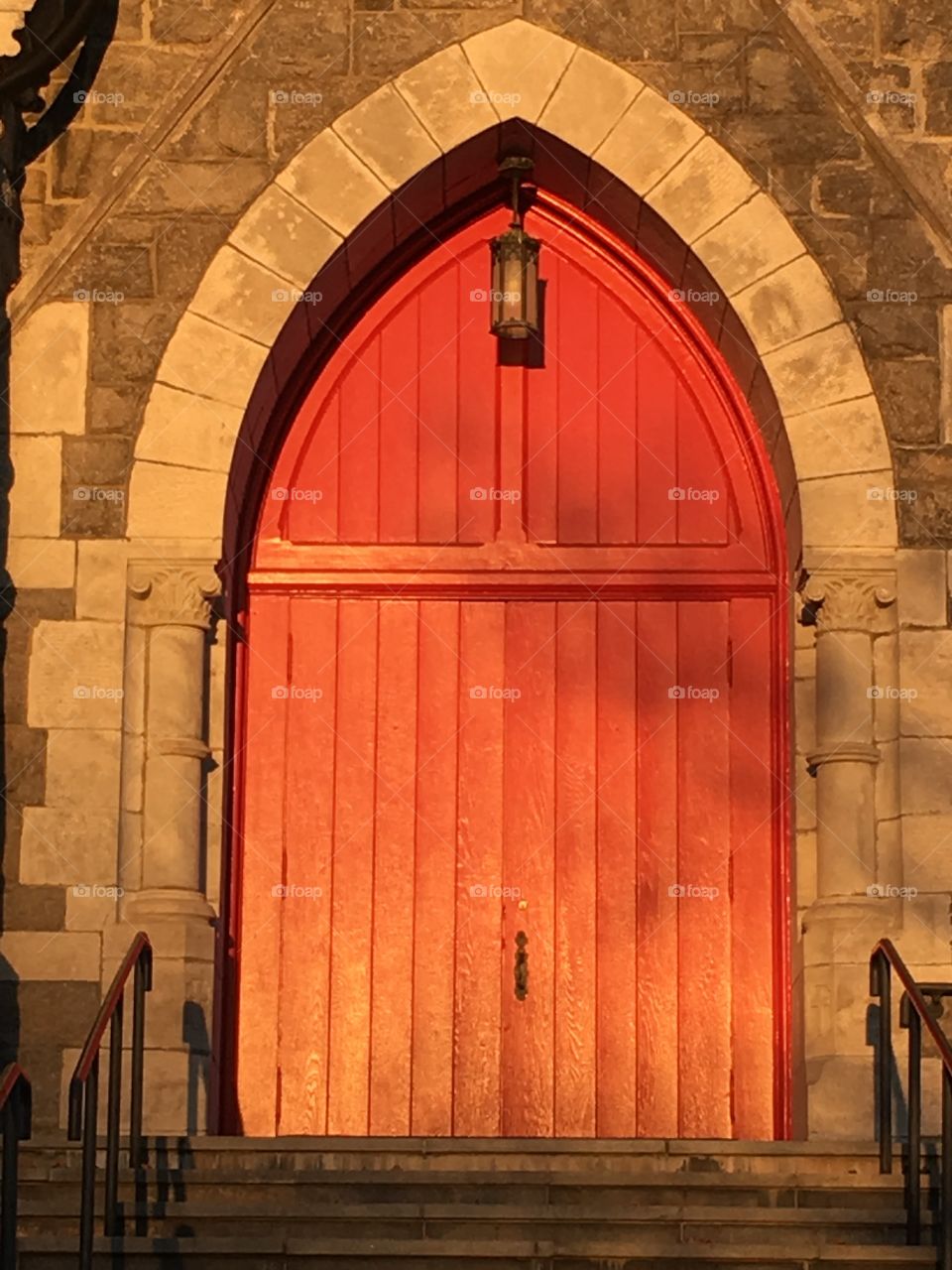 Red church door at sunset