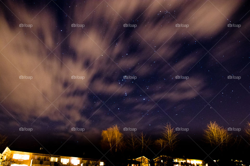 stars and wispy clouds over the neighbourhood on a cold January night in Sweden