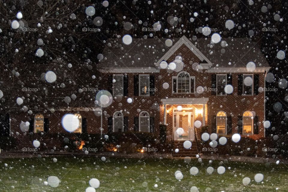 Flash Illuminated Snowflakes in Front of a House