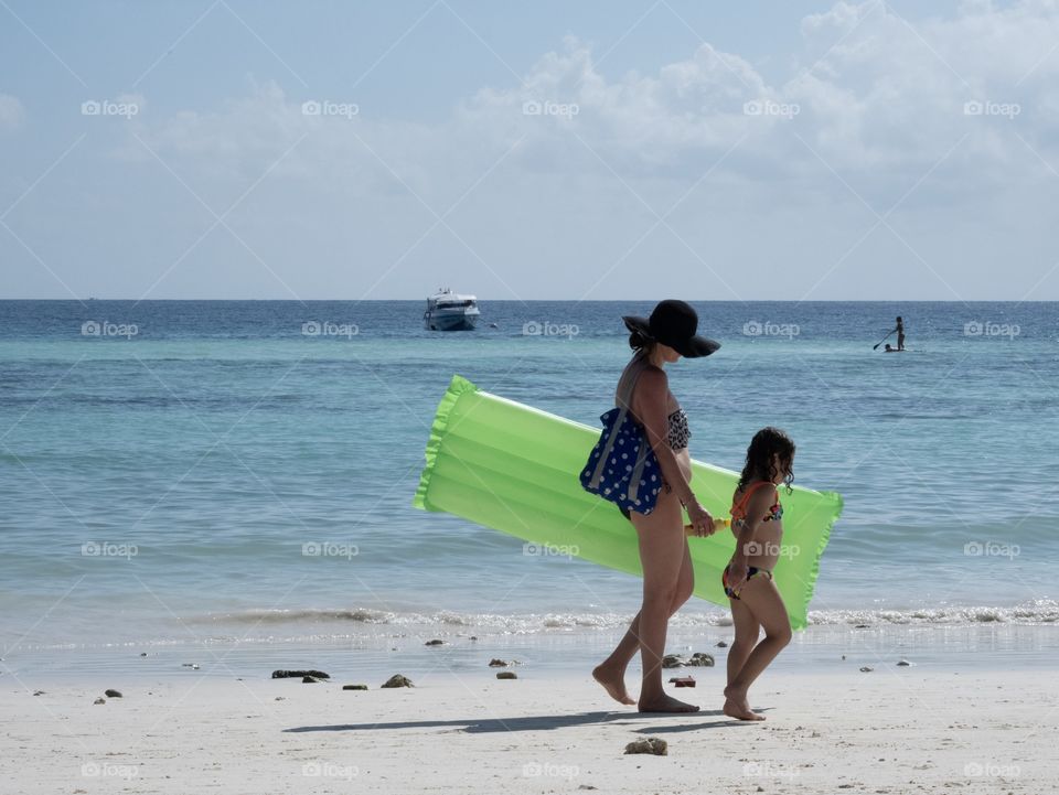 Mom and Daughter take a rest on the beautiful beach together 