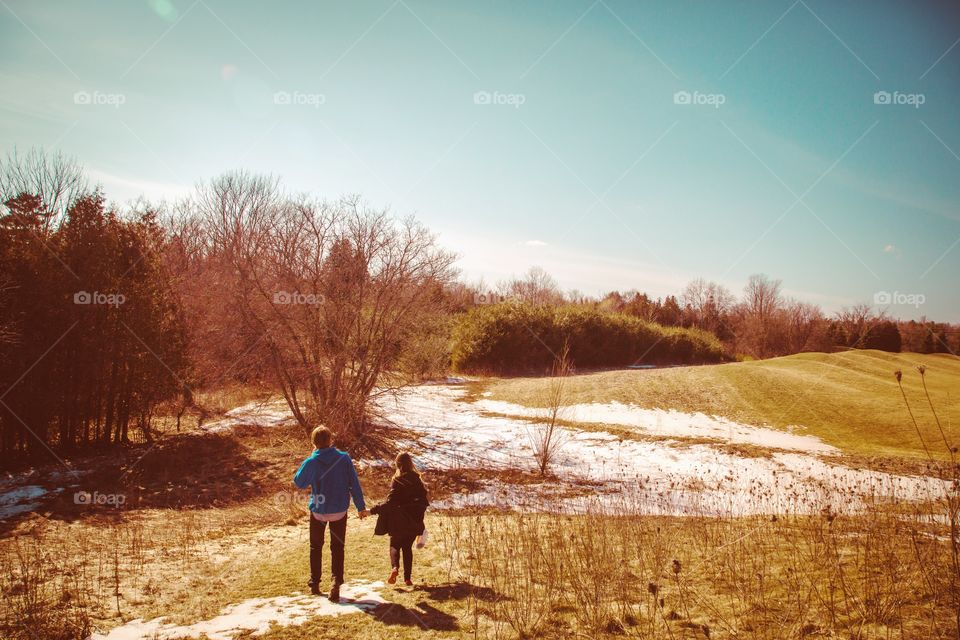 A young couple walking on forest trails