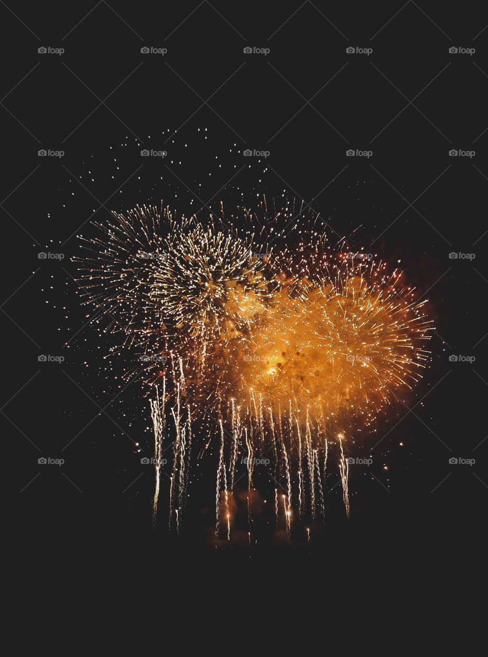 Photograph of the fireworks display for The Minneapolis Aqutennial. In downtown Minneapolis over looking the Mississippi river.