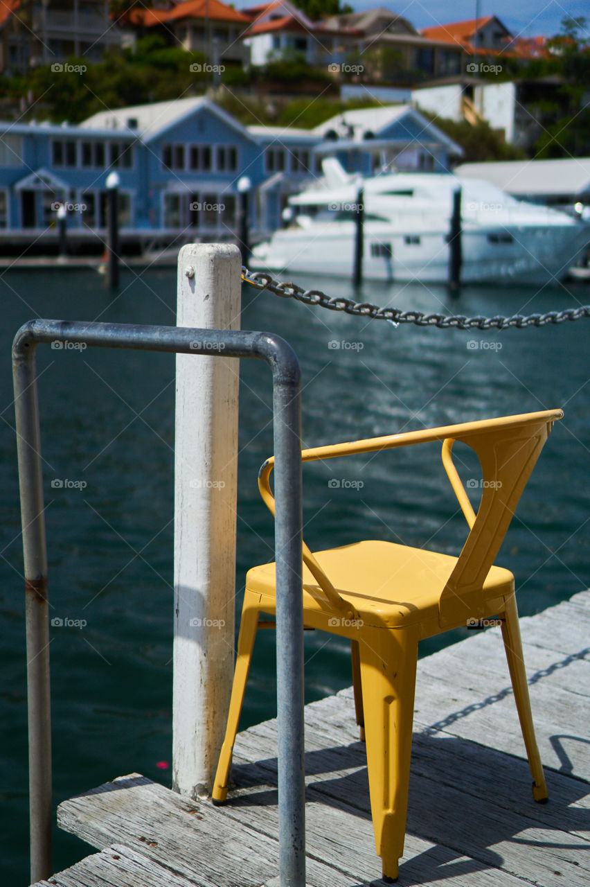 Abandoned yellow chair in the docks