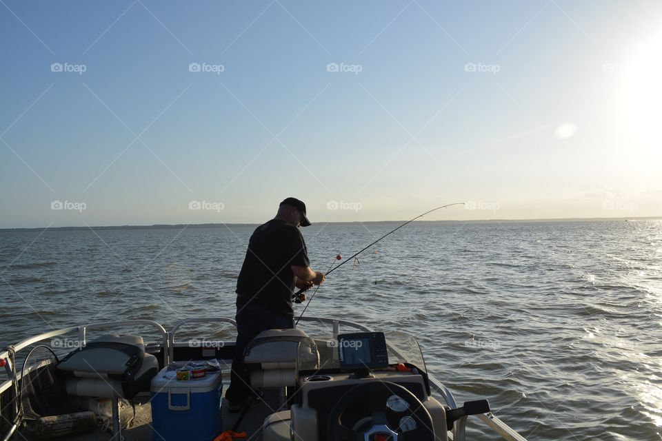 My husband fishing on lake Livingston off the boat