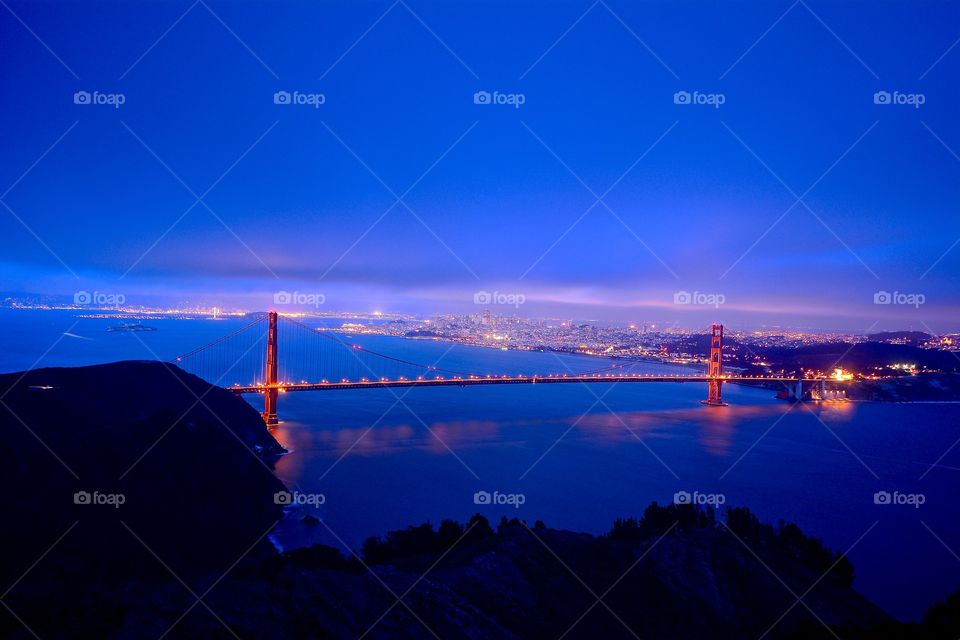 A glowing Golden Gate Bridge during the blue hour