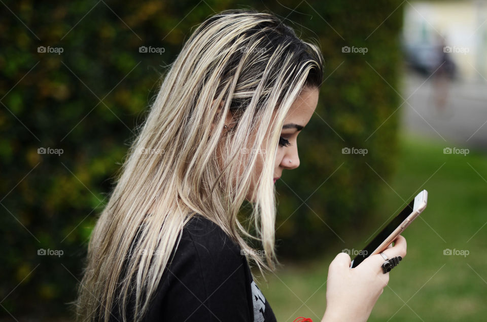 Side view of a girl using cellphone
