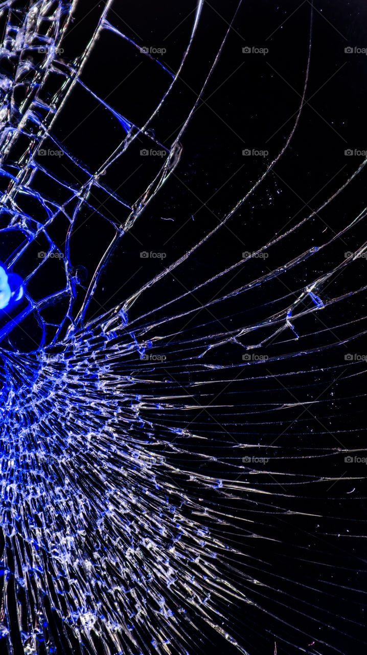 Multi-colored and bright broken smartphone screen close-up.