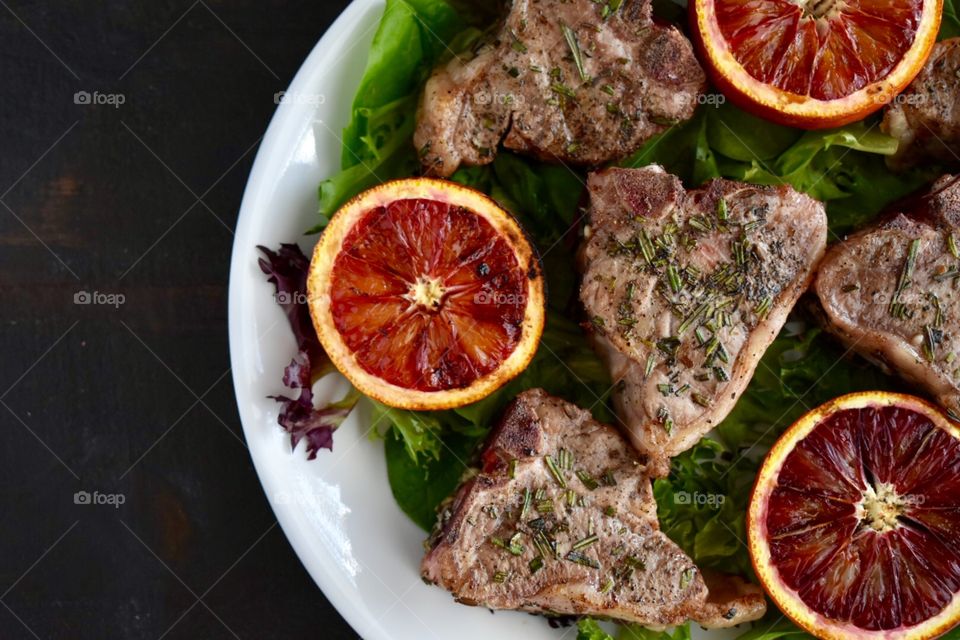 Grilled lamb chops and blood oranges on a bed of spring greens