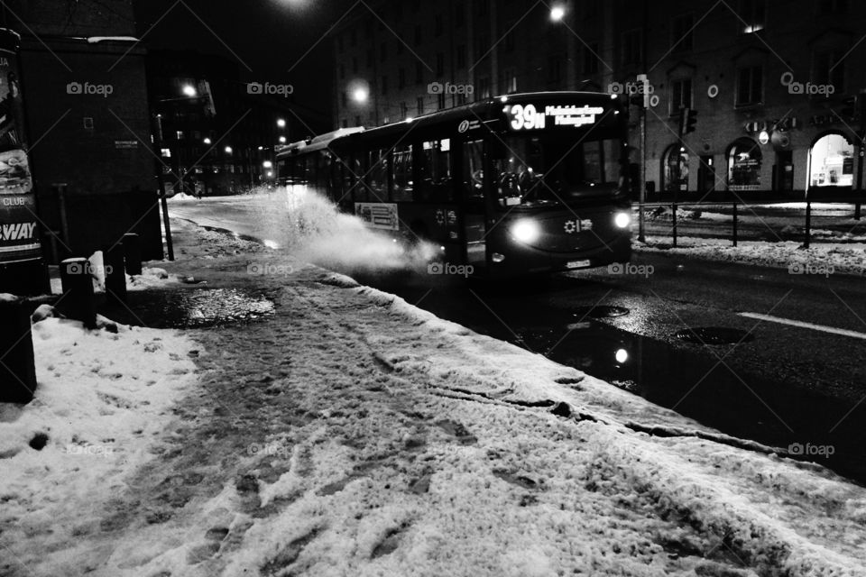 Helsinki, Finland - 9 January 2012:  A Helsinki city bus 39 driving on Runeberginkatu in the center of Helsinki in wet winter weather.