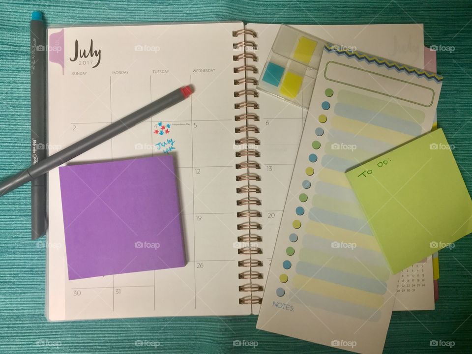 Monthly planner, to-do list, pens and sticky notes flat layout 