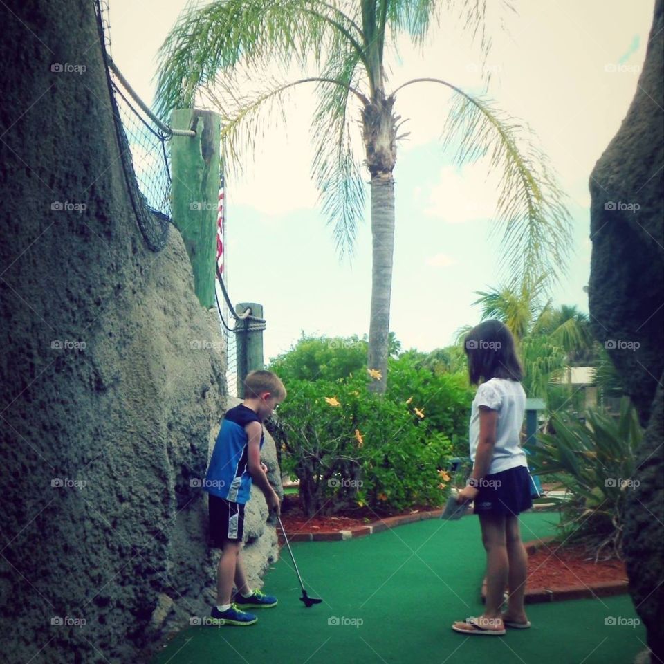Playing mini golf 