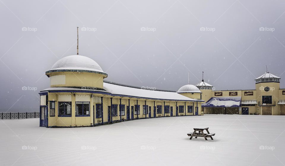An old boarded up pier covered in snow
