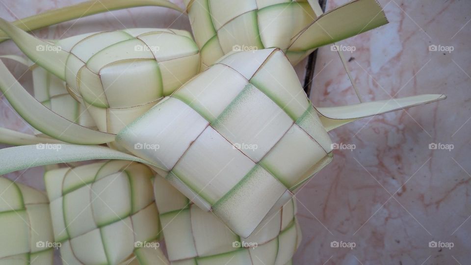 Making ketupat on the terrace of the house