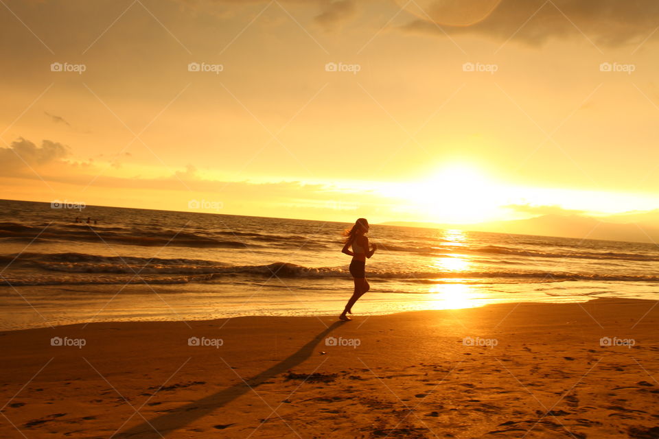 Sunset runner. Runner at beach sunset