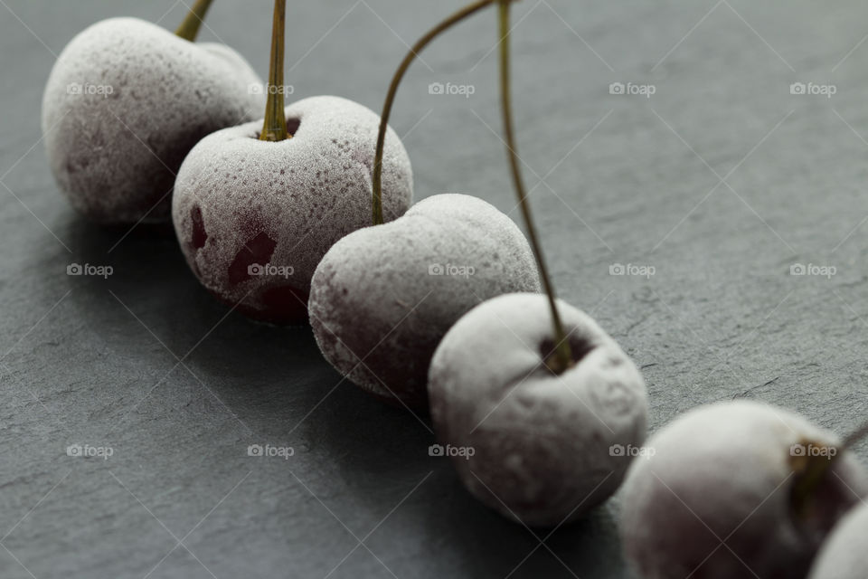 Group Of Frozen Cherries on a dark background Close Up