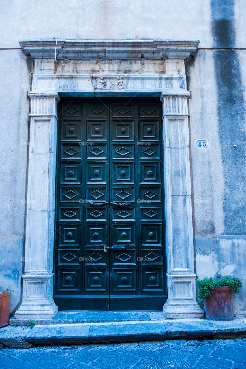 Old door in the city of Cefalu on Sicily.