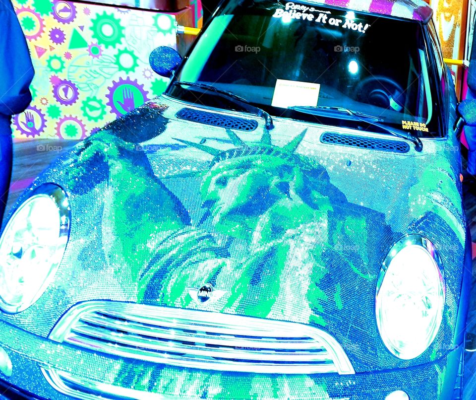 Amazingly unique urban hip mini cooper at Ripleys decked out in millions of shimmering crystals creating artistic murals of american icons.