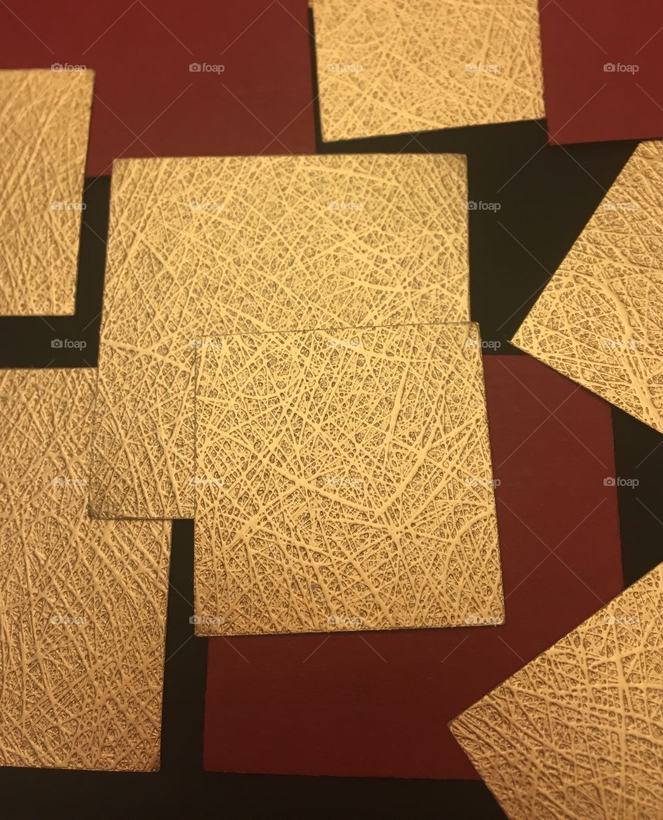 Scrapbook paper squares on a black canvas. 