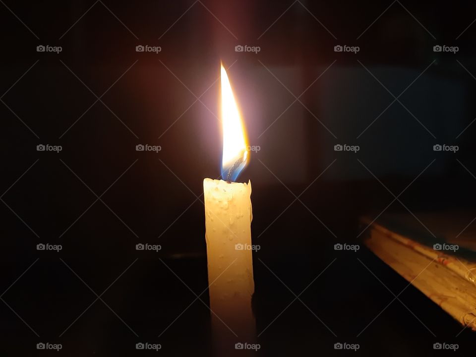 white candle on black background