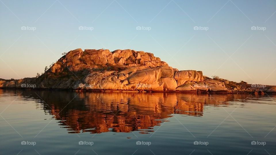 Cliff reflecting in sea