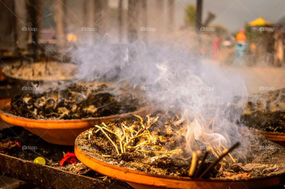 Soil clay lamp radiating light flame and smoke. Removing darkness concept. Widely used south east India Nepal in diwali celebration. Make with cotton wick decoration uses in religious festivals.