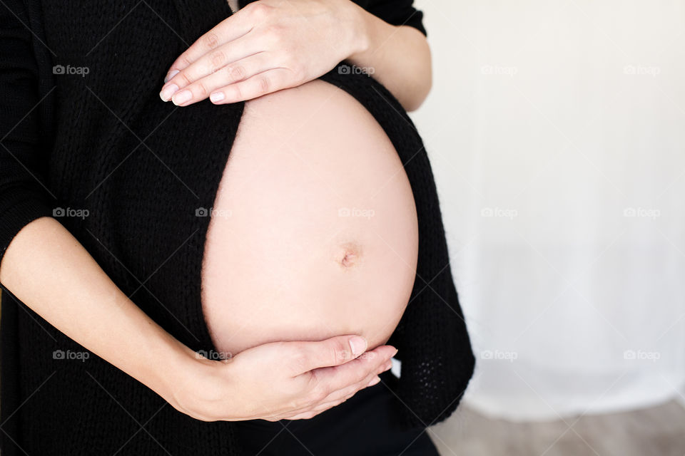 Pregnant women touching her belly