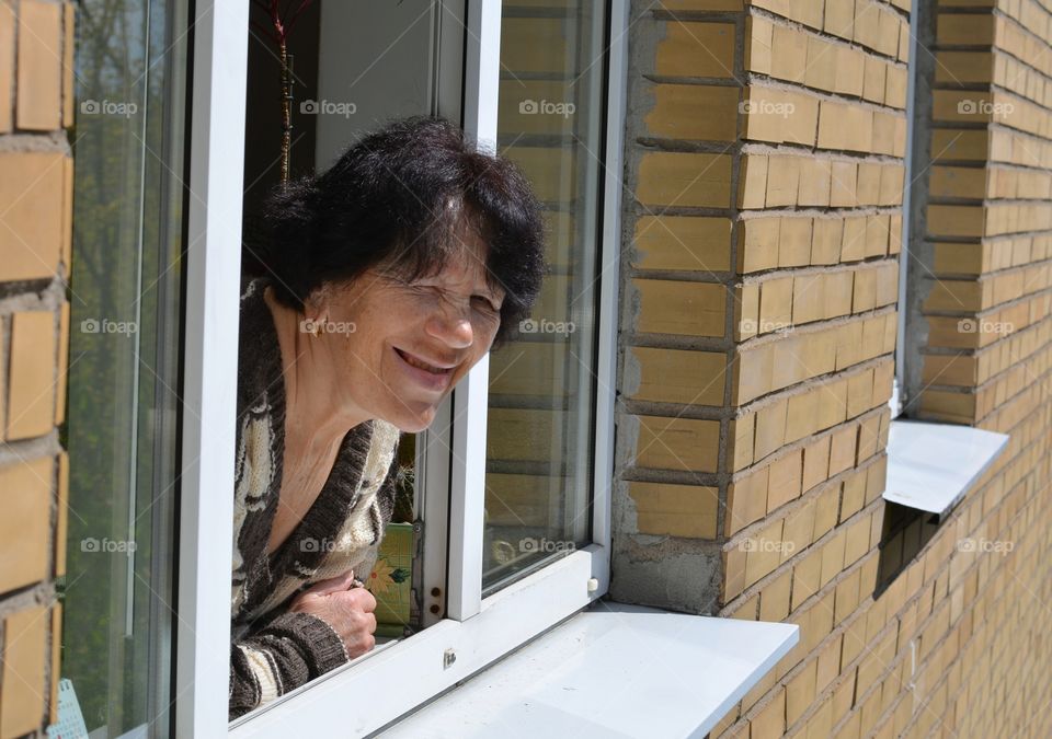 woman looking in window home emotions