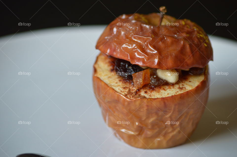 baked apple with cinamon and nuts in macro