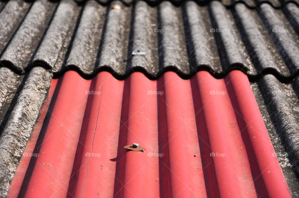 Old red and gray roof tiles texture. Corrugated roof tiles.