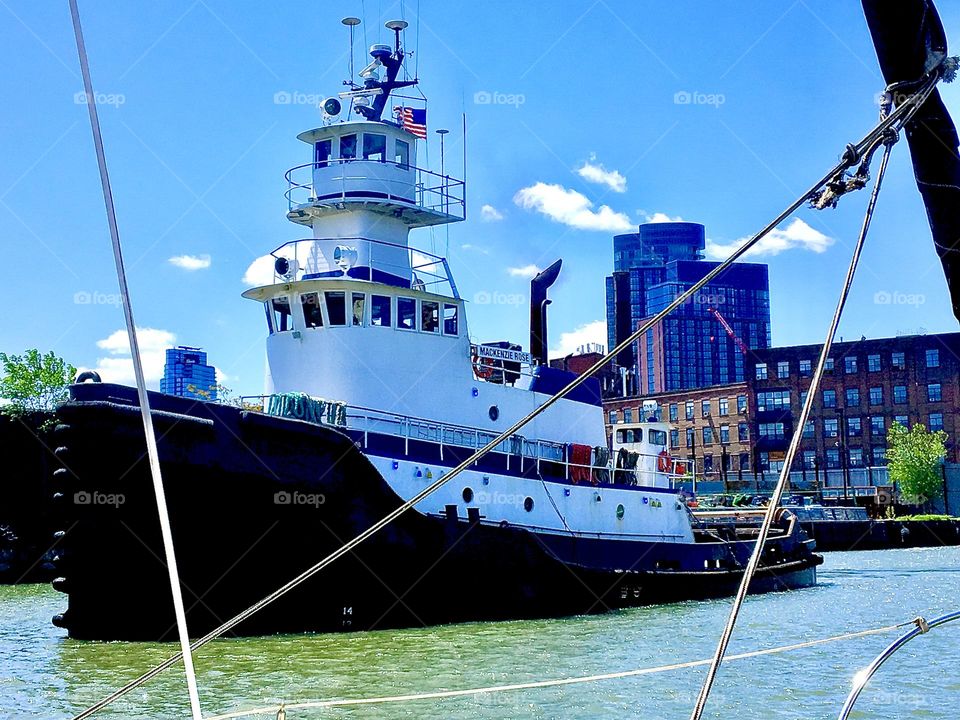 A big ship is passing us by on the East River here in Newtown Creek in LIC, Queens, NY. Our boat is 28 ft long whereas this one measures 55 ft or more easily. It has three main levels and a three stack high fly bridge. 2022. Hypnotic Productions