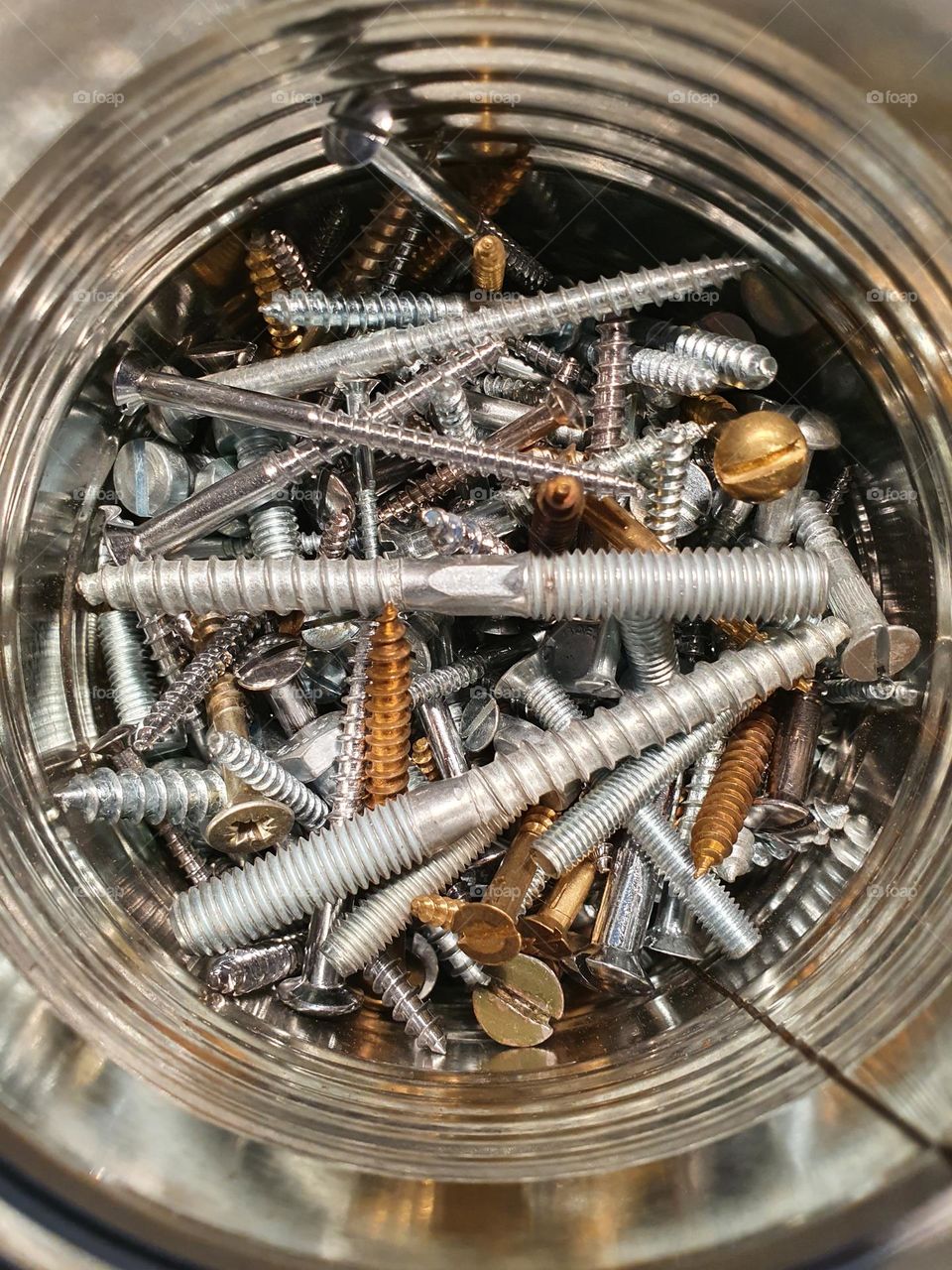 tin filled with various metal screws