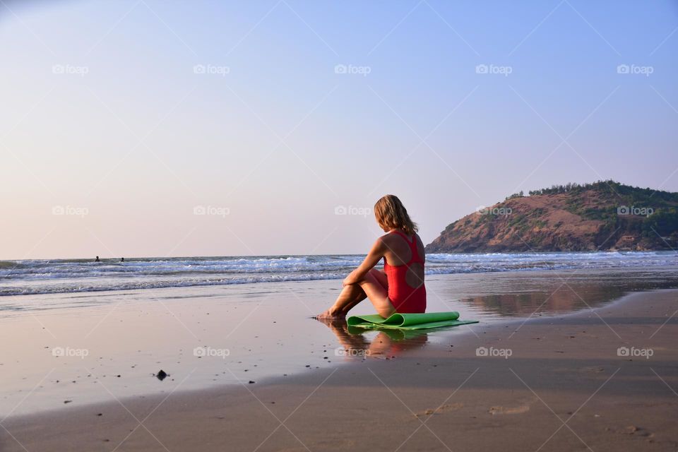 Woman on a serene beach of Goa