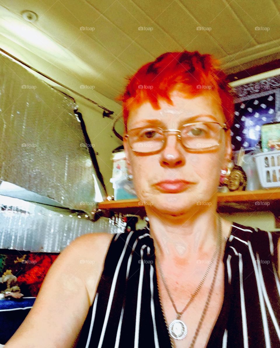Dressed in a black & white stripe motif I, „Petra Schiller“ a.k.a. „Maximiliane Feuerfuchs“ am sitting quietly by the high power fan to stay cool in the hot summer weather aboard „Salvation“, our „1969 Luhrs“ cabin cruiser. 2019. Hypnotic Productions