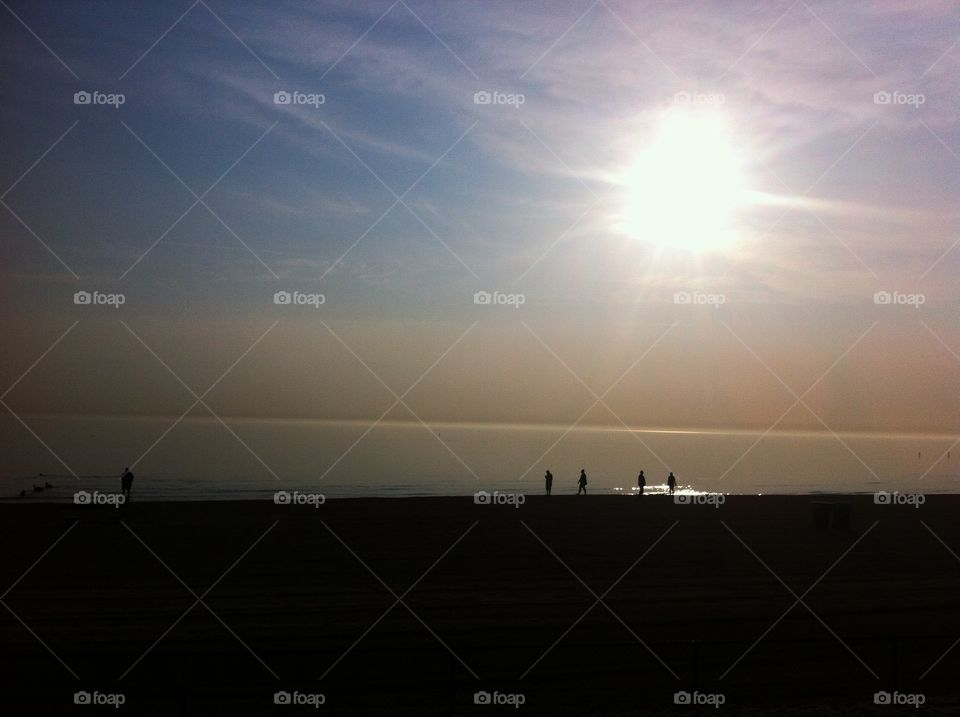 Early Morning Dog Beach. Early morning summer run along Chicago's lakefront. Saw people backlit at the dog beach. 