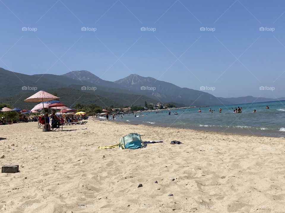 Sunny holidays I’m Turkey. Walk in the cute city and charming streets by the beach in Kusadasi. perfect blue sky and ocean view. Beach and the shore. To travel is to live. Gorgeous tall palm trees.