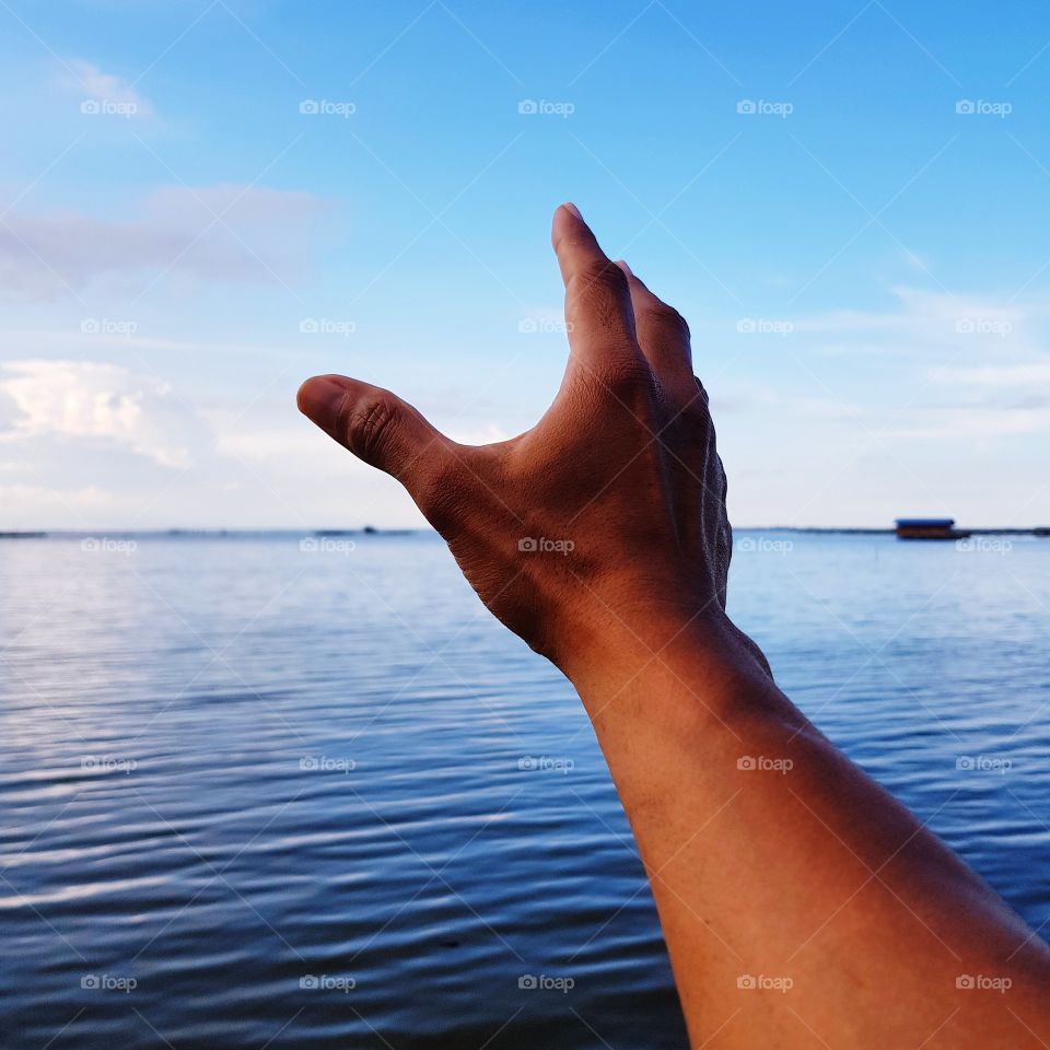 Hand reaching sky