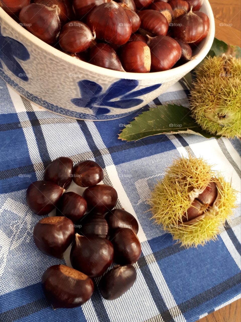 chestnuts in a blue and white bowl on a blue and white towel