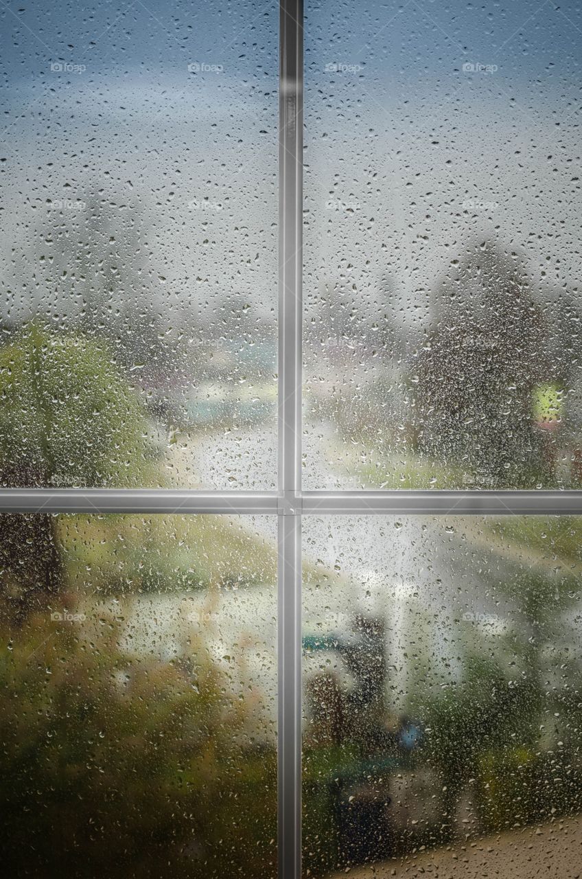 A wet window a drop of rain
