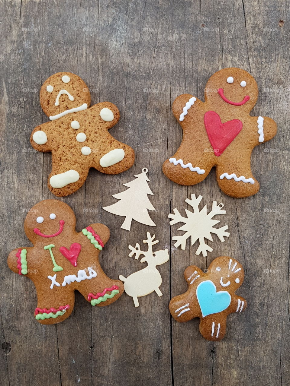 Merry Christmas with gingerbread cookies and wooden ornaments

