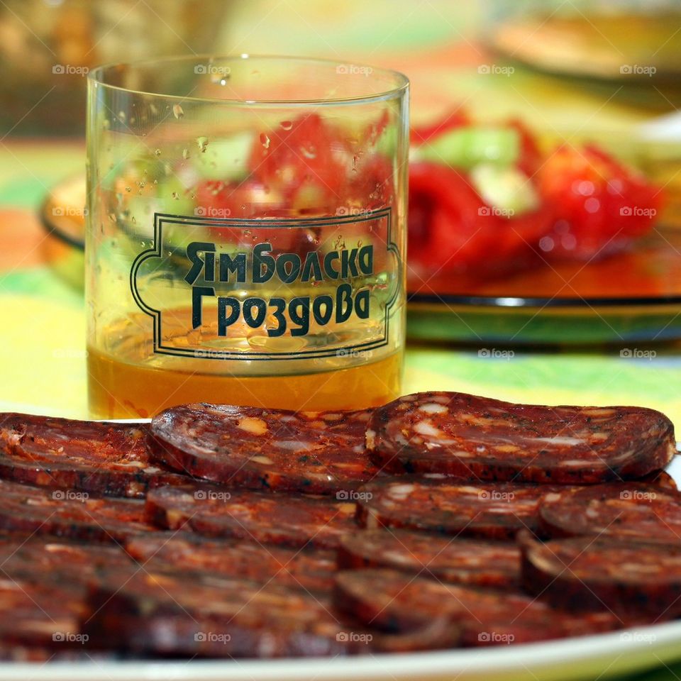 Sliced meat with salad and alcohol