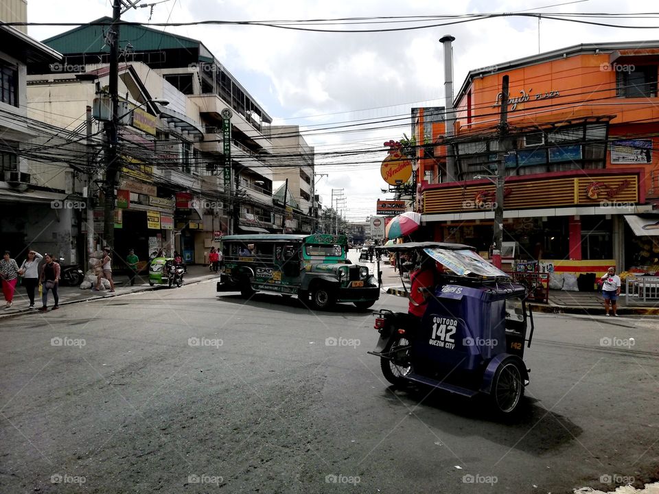 Tuk tuk and jeepney on the street in Quezon City, Metro Manila, Luzon Philippines; traffic on busy South East Asian street