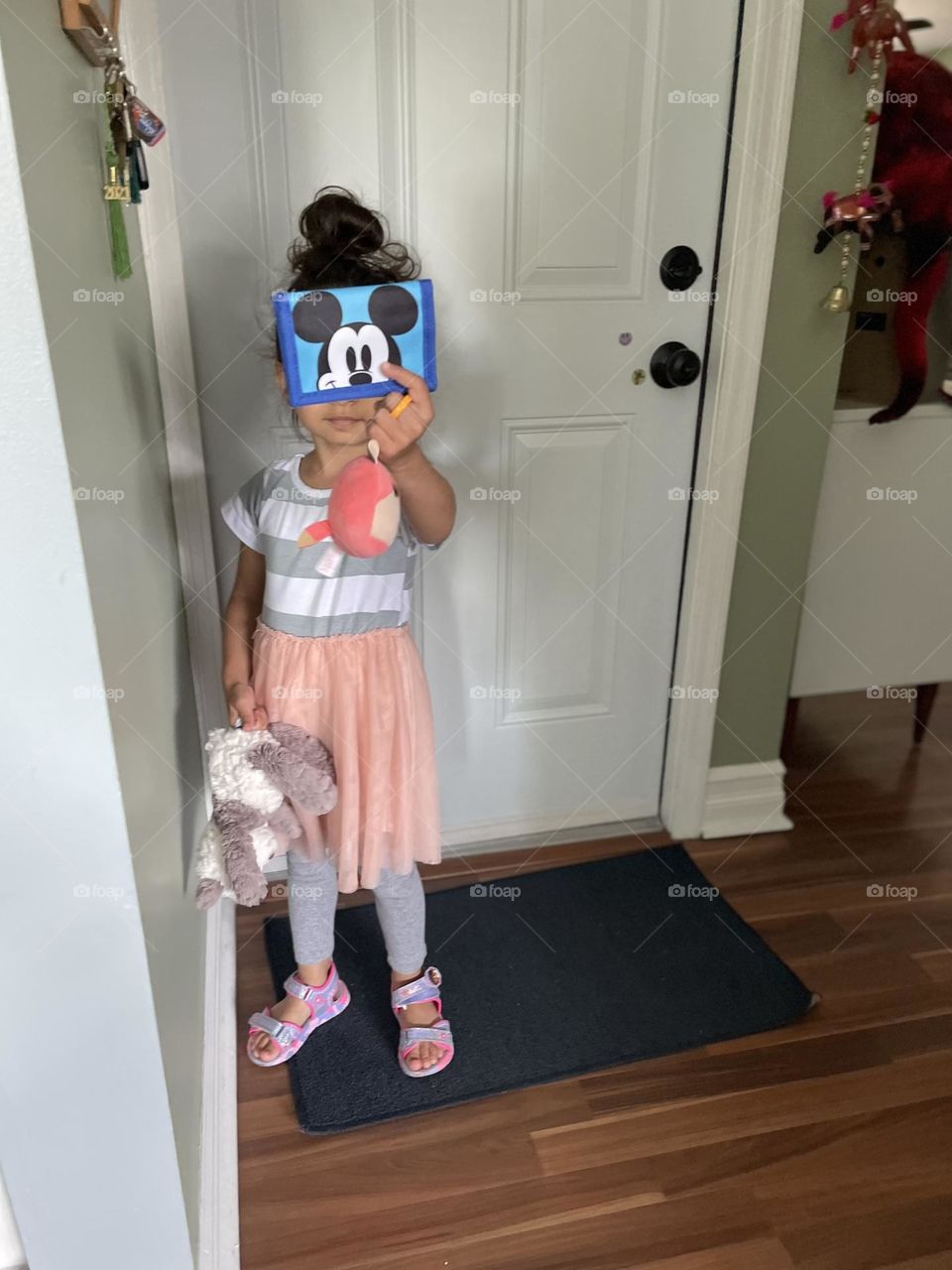 Little girl excited to go shopping with Mommy, little girl has a Mickey Mouse wallet, toddler girl has her own money and wallet, shopping with Mommy 