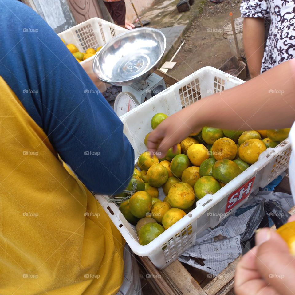 Pile of oranges in a plastic basket ready to be sold
