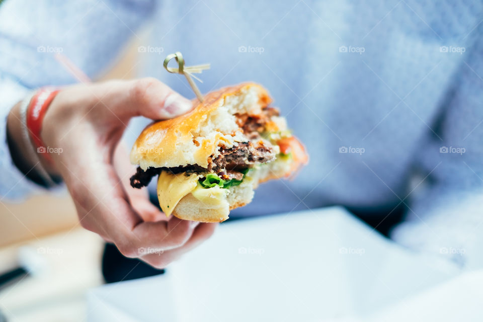 Business man eating burger 