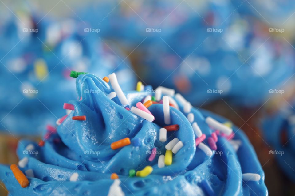 Blue Frosting. A cupcake with blue frosting and sprinkles.